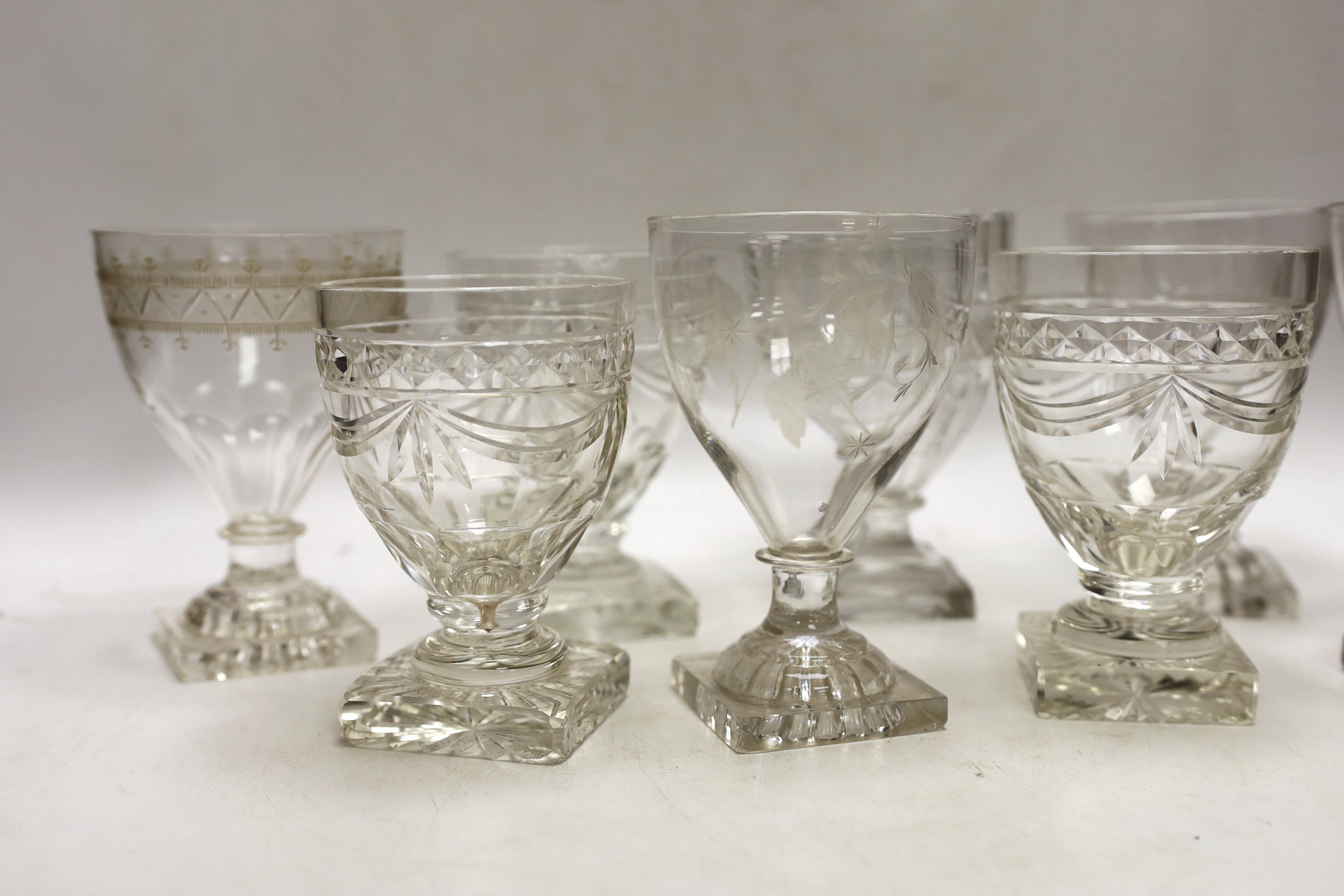 Three late 19th early 20th century square base wine glasses, three similar etched glasses and another (8)